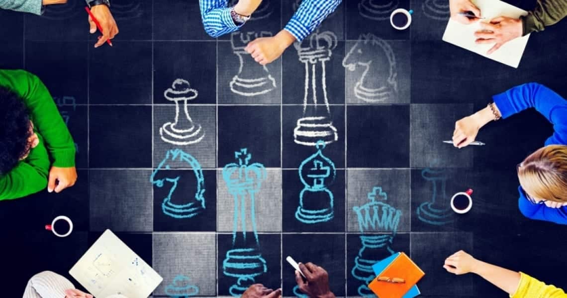 People playing chess on a table.